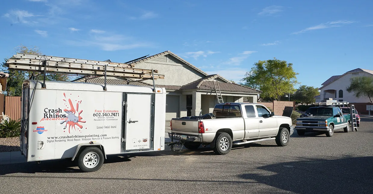 Before: a single Crash of Rhinos Painting truck and work trailer parked in a driveway